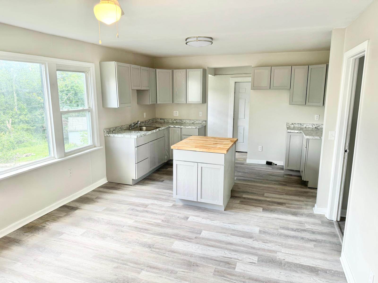 Completed kitchen remodel with updated cabinets, counters, and interior finishes
