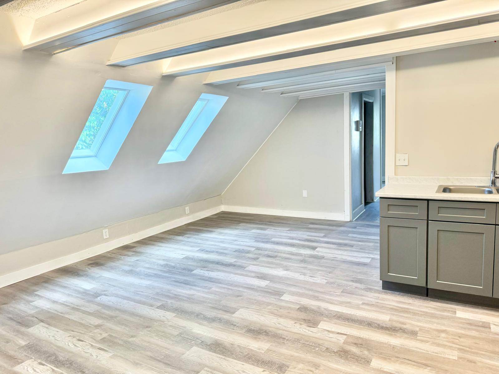 Interior renovation work with finished flooring, walls, and property closeout details